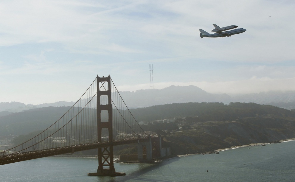 Retired space shuttle Endeavour is carried on the back of a NASA jet as it approaches the Golden Gate Bridge in San Francisco