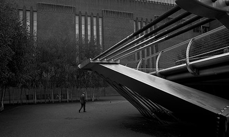 A man walks between the Millenium Bridge and the tate Modern Art Gallery in London Antonio Olmos