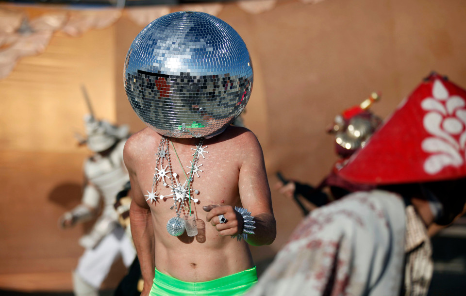 Ciberfy, his play name, dances at sunrise during the Burning Man 2012 "Fertility 2.0" arts and music festival in the Black Rock Desert of Nevada